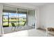 Screened-in patio with outdoor seating overlooking a serene pond and well-manicured lawns at 4914 Sienna Isles Ave, Wimauma, FL 33598