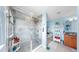 This bathroom boasts a glass-enclosed shower, with a separate soaking tub, and lovely light blue walls at 5040 Inshore Landing Dr, Apollo Beach, FL 33572