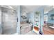 Serene bathroom with a soaking tub, walk-in shower, stylish decor, and calming blue walls, designed for relaxation at 5040 Inshore Landing Dr, Apollo Beach, FL 33572