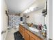 Bathroom featuring double sinks, granite countertops, and a shower with a floral curtain, designed for comfort and convenience at 5040 Inshore Landing Dr, Apollo Beach, FL 33572