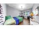 Bright bedroom with ample natural light and a charming chandelier is perfect for relaxing or working from home at 5040 Inshore Landing Dr, Apollo Beach, FL 33572