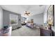 bedroom featuring grey walls, neutral carpet, ceiling fan, and large windows at 5040 Inshore Landing Dr, Apollo Beach, FL 33572