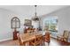 Dining room with natural light, rustic table, hardwood floors and neutral paint at 5040 Inshore Landing Dr, Apollo Beach, FL 33572