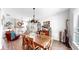 Well-lit dining room with wooden table, chandelier, and a rustic fireplace at 5040 Inshore Landing Dr, Apollo Beach, FL 33572