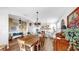 Inviting dining room with hardwood floors, rustic wood table, decorative chandelier, and exposed brick fireplace at 5040 Inshore Landing Dr, Apollo Beach, FL 33572