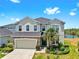 This home has amazing curb appeal, lush landscaping, and a gorgeous lake view from the front yard at 5040 Inshore Landing Dr, Apollo Beach, FL 33572