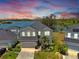 Beautiful two-story home with stone accents, lush landscaping, and serene lake views at 5040 Inshore Landing Dr, Apollo Beach, FL 33572