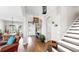 Inviting foyer with hardwood floors, elegant lighting, a shiplap wall, and an open view of the dining area at 5040 Inshore Landing Dr, Apollo Beach, FL 33572