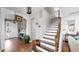 Welcoming foyer featuring hardwood floors, staircase, white shiplap walls, and decorative lighting at 5040 Inshore Landing Dr, Apollo Beach, FL 33572