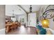 Charming foyer featuring a bright light fixture, bench, and view into the dining area with table and chairs at 5040 Inshore Landing Dr, Apollo Beach, FL 33572
