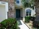 This home welcomes you with a garden and stone details on the facade leading up to the front door at 5040 Inshore Landing Dr, Apollo Beach, FL 33572