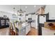 Open concept kitchen with granite counters, stainless appliances, breakfast bar, and brick accent wall at 5040 Inshore Landing Dr, Apollo Beach, FL 33572