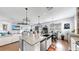Open concept kitchen with granite counters, farmhouse sink, stainless appliances and an island with pendant lighting at 5040 Inshore Landing Dr, Apollo Beach, FL 33572