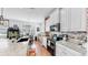 Bright eat-in kitchen with granite counters, stainless appliances, farmhouse sink and brick accent wall at 5040 Inshore Landing Dr, Apollo Beach, FL 33572