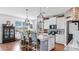 Open concept kitchen with granite counters, stainless appliances, breakfast bar, and brick accent wall at 5040 Inshore Landing Dr, Apollo Beach, FL 33572