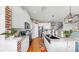 Modern kitchen with white cabinets, granite countertops, stainless steel appliances, and exposed brick accents at 5040 Inshore Landing Dr, Apollo Beach, FL 33572
