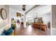 Bright open-concept living and dining area with hardwood floors, arched doorways, and elegant chandeliers, perfect for entertaining at 5040 Inshore Landing Dr, Apollo Beach, FL 33572