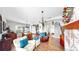 Open concept living area with hardwood floors, brick fireplace, dining room and front entrance at 5040 Inshore Landing Dr, Apollo Beach, FL 33572