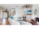 Bright living room with a cozy fireplace, shiplap wall paneling, and modern decor at 5040 Inshore Landing Dr, Apollo Beach, FL 33572