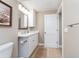 Bright bathroom with white cabinets, quartz countertops, and a modern vanity setup at 51 Island Way # 503, Clearwater Beach, FL 33767