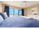 This bedroom has a blue quilted comforter, a white dresser, and a balcony with a view at 51 Island Way # 503, Clearwater Beach, FL 33767