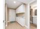 Hallway featuring ample storage and access to bathroom, with door and modern cabinets at 51 Island Way # 503, Clearwater Beach, FL 33767