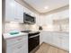 Modern kitchen featuring stainless appliances, white cabinets, tile backsplash and updated finishes at 51 Island Way # 503, Clearwater Beach, FL 33767