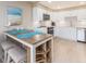Bright kitchen and eat-in nook featuring white cabinetry and stainless steel appliances at 51 Island Way # 503, Clearwater Beach, FL 33767