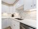 Beautiful kitchen with stainless steel appliances, white cabinets, and a stylish backsplash at 51 Island Way # 503, Clearwater Beach, FL 33767