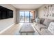 Comfortable living room featuring a large sliding glass door and modern furnishings at 51 Island Way # 503, Clearwater Beach, FL 33767