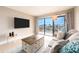 Cozy living room featuring a sliding glass door to balcony and comfortable furnishings at 51 Island Way # 503, Clearwater Beach, FL 33767