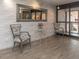 Comfortable lobby area with chairs, table, decorative mirror and tiled accent wall at 51 Island Way # 503, Clearwater Beach, FL 33767