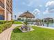 Picturesque waterfront patio with tiki umbrellas and comfortable seating, ideal for outdoor relaxation and enjoying scenic views at 51 Island Way # 503, Clearwater Beach, FL 33767