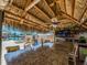 Outdoor tiki bar with granite countertops, a TV, and barstools, perfect for outdoor entertaining near the water at 51 Island Way # 503, Clearwater Beach, FL 33767