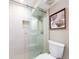 Modern shower with glass door, tile accents, and rainfall shower head in a renovated bathroom at 51 Island Way # 503, Clearwater Beach, FL 33767