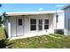 Back patio area with a door and large windows looking into the home at 5714 Cheyenne St, Zephyrhills, FL 33542
