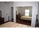 Bedroom view showcasing a mirrored closet, hardwood floors and natural light at 5714 Cheyenne St, Zephyrhills, FL 33542