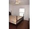 Cozy bedroom with hardwood floors, white walls and a ceiling fan at 5714 Cheyenne St, Zephyrhills, FL 33542