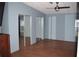 Spacious bedroom with hardwood floors and a large mirrored closet at 5714 Cheyenne St, Zephyrhills, FL 33542