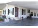 Inviting mobile home exterior with a covered carport and cozy front entrance with dark shutters at 5714 Cheyenne St, Zephyrhills, FL 33542