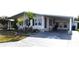 Charming mobile home with a covered carport, landscaped front yard, and delightful curb appeal at 5714 Cheyenne St, Zephyrhills, FL 33542