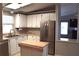 Open kitchen with stainless steel appliances, light countertops and tile backsplash at 5714 Cheyenne St, Zephyrhills, FL 33542
