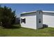 Outbuilding in the yard with white siding and a small window at 5714 Cheyenne St, Zephyrhills, FL 33542