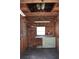Interior shed features wooden walls, shelving, and a workbench with storage, providing a functional workspace at 5714 Cheyenne St, Zephyrhills, FL 33542