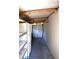 A long storage area with white metal shelving and a white freezer or refrigerator for plenty of storage at 5714 Cheyenne St, Zephyrhills, FL 33542