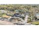 A beautiful home boasts mature trees and a circular driveway in an aerial view at 5744 150Th N Ave, Clearwater, FL 33760