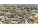 An elevated view of the home nestled among mature trees, featuring a circular driveway and a glimpse of the surrounding neighborhood at 5744 150Th N Ave, Clearwater, FL 33760