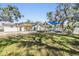 Spacious backyard with a pergola, modern lounge furniture, and lush green lawn at 5744 150Th N Ave, Clearwater, FL 33760