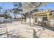 Outdoor patio area featuring pavers, a pergola, a basketball hoop, and providing an inviting space for outdoor entertaining at 5744 150Th N Ave, Clearwater, FL 33760