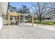 Inviting backyard featuring a paved patio with a pergola, a covered seating area, and ample space for outdoor activities at 5744 150Th N Ave, Clearwater, FL 33760